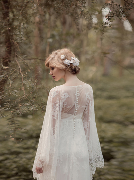 Vintage button up long sleeve lace wedding dress with floral bridal updo. 